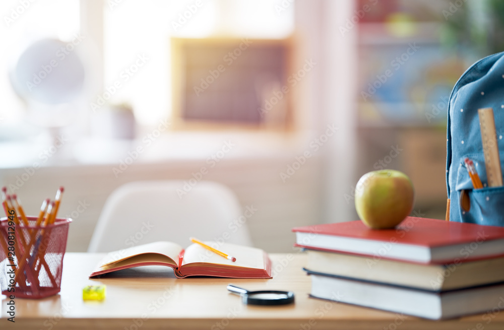 Apple, pile of books and backpack Apple, pile of books and backpack
