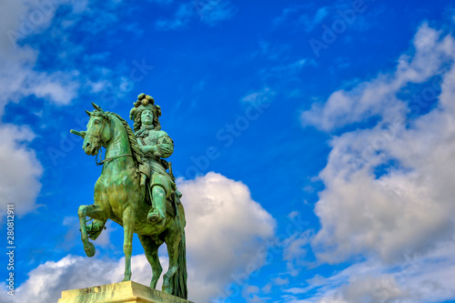 Versailles  France - April 24  2019  Louis XIV statue just outside of the gates of Versailles Palace on a sunny day outside of Paris  France.
