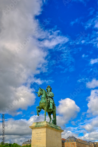 Versailles, France - April 24, 2019: Louis XIV statue just outside of the gates of Versailles Palace on a sunny day outside of Paris, France.