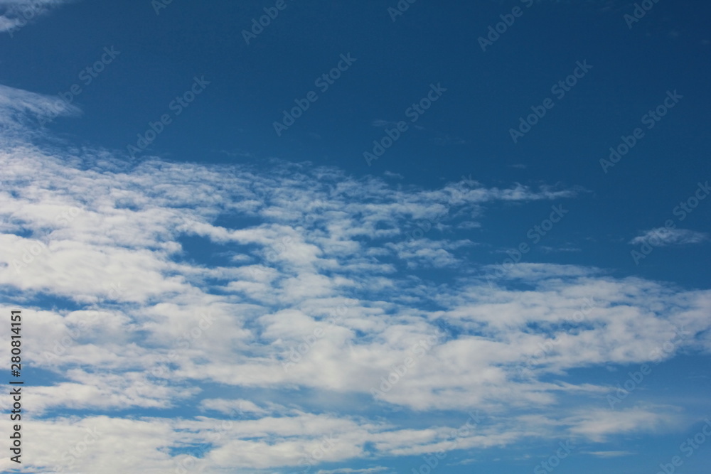 Fantastic soft white clouds against blue sky on background Fantastic soft white clouds against blue sky on background