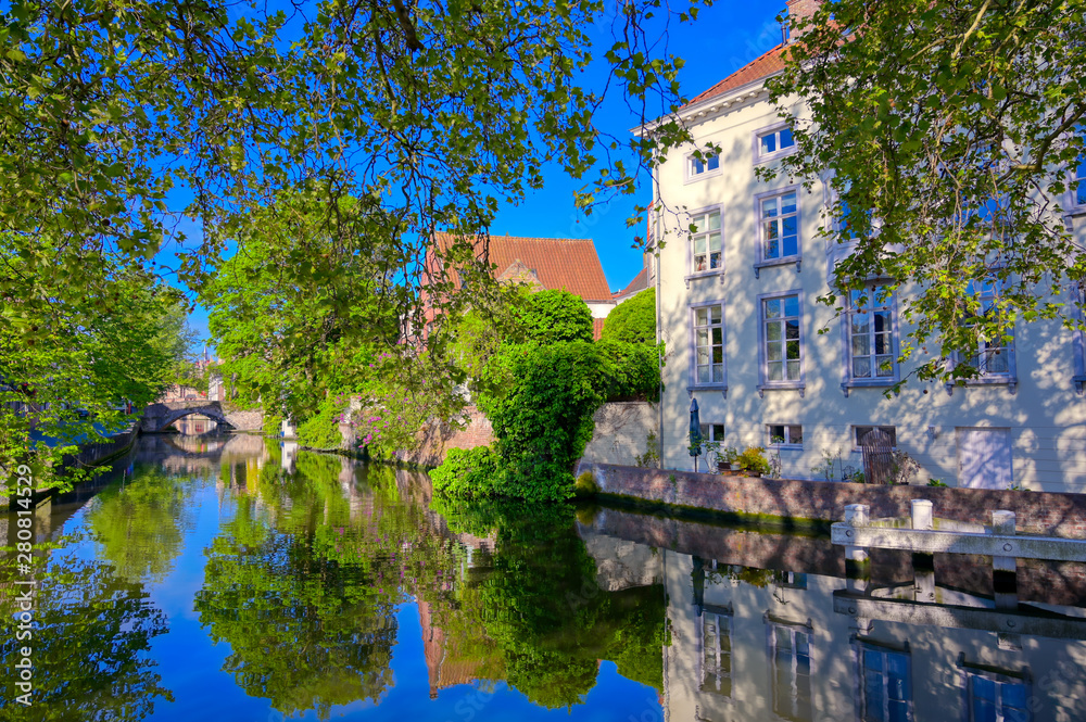 The canals of Bruges (Brugge), Belgium on a sunny day. The canals of Bruges (Brugge), Belgium on a sunny day.