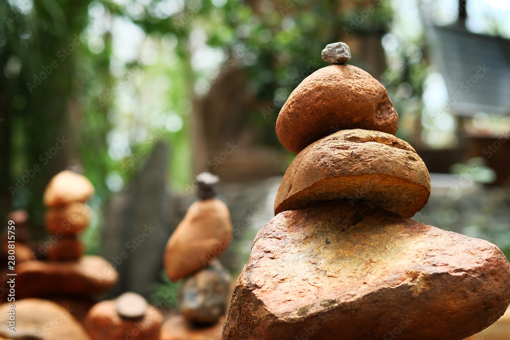 Create balance with meditation rock tower for make meditation peaceful with forest background with daylight Create balance with meditation rock tower for make meditation peaceful with forest background with daylight