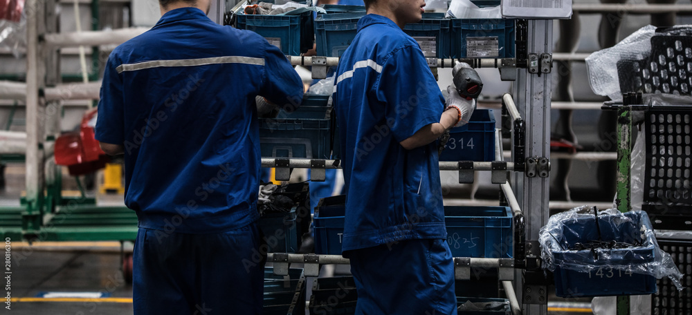 Workers in machinery factory in China. Workers in machinery factory in China.