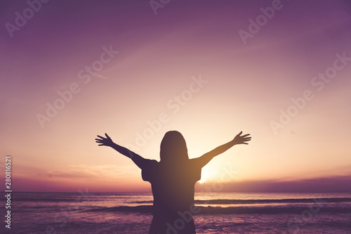 Woman rise hands up to sky freedom concept with blue sky. © ant