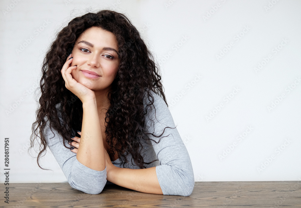 Portrait of a african woman wearing casual posing over white background at home Portrait of a african woman wearing casual posing over white background at home