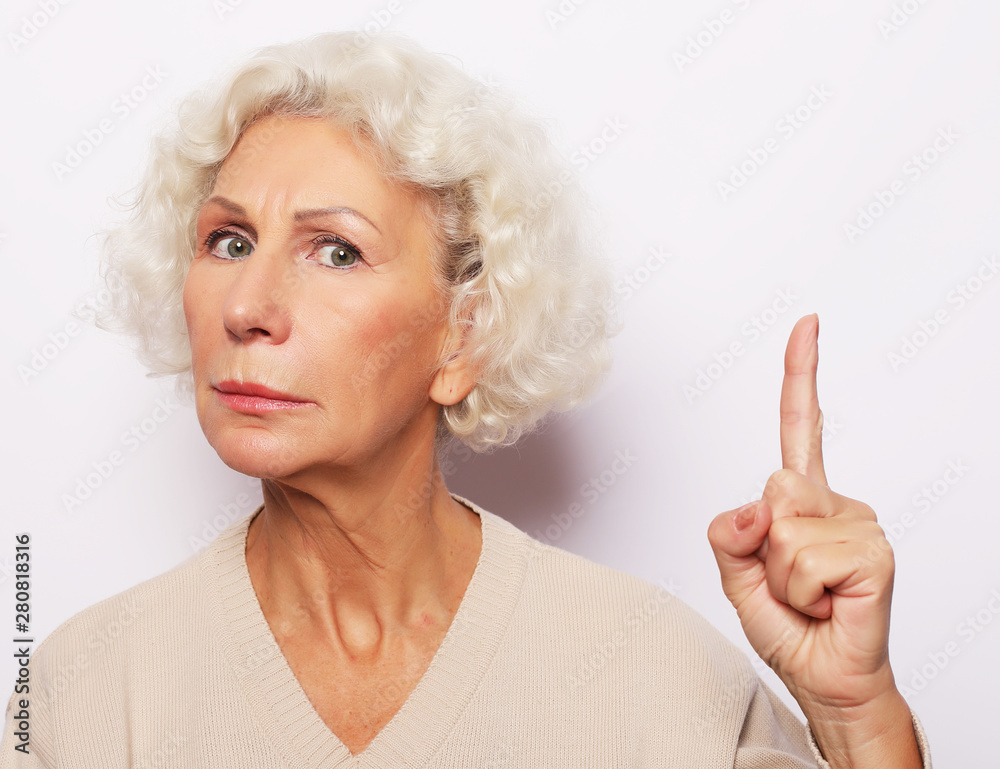 lifestyle, emotion and people concept - senior woman show something over white background