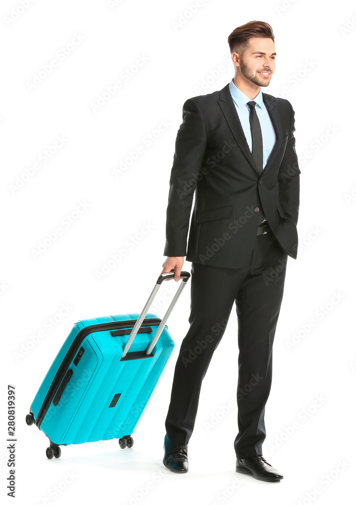 Handsome young businessman with luggage on white background