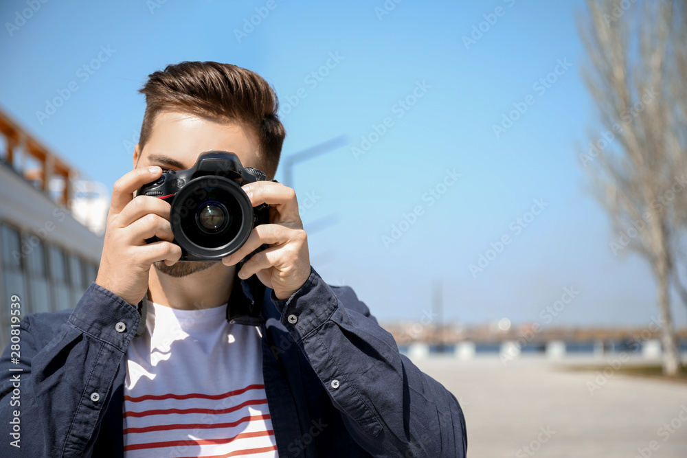 Handsome male photographer outdoors
