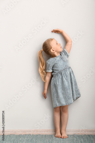 Little girl measuring heigh...
