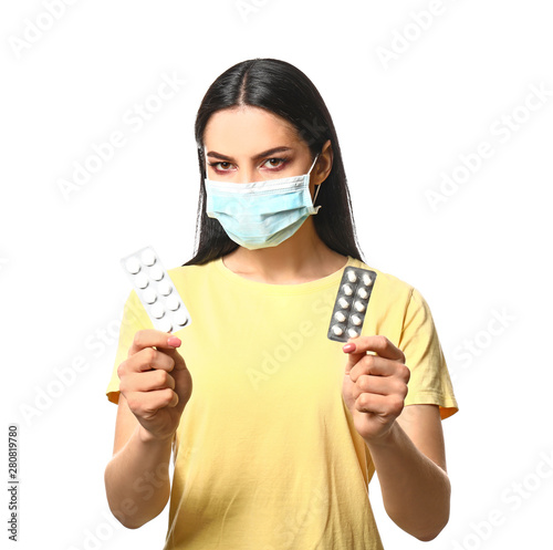Young woman with pills wear...