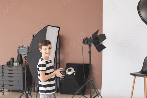 Cute little photographer in professional studio