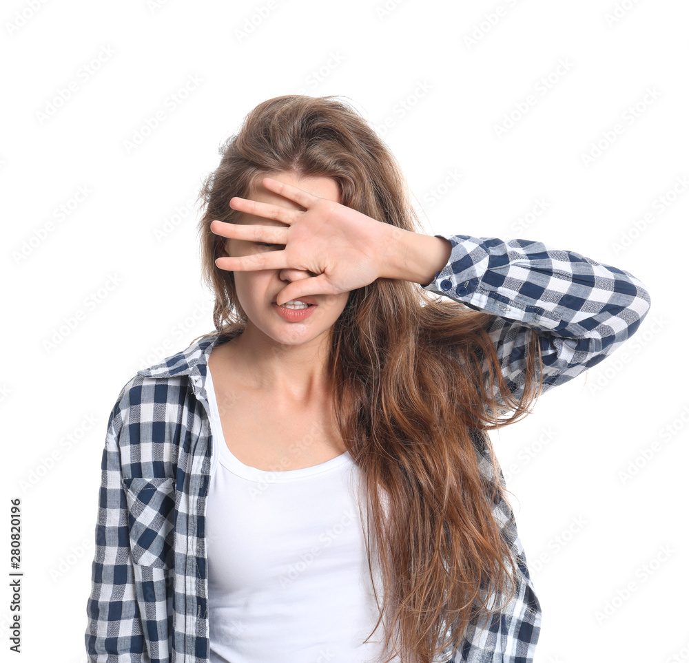 Young woman covering her eyes on white background Young woman covering her eyes on white background