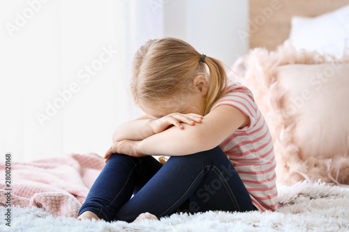 Crying little girl sitting ...