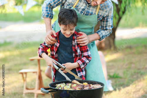 Little boy with father cook...