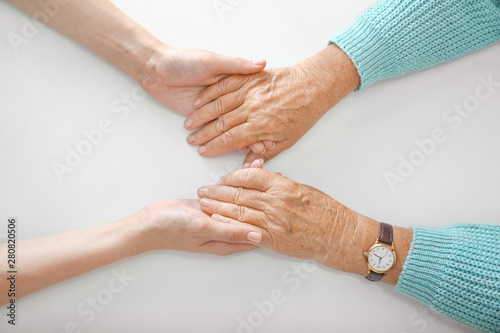 Hands of young and elderly ...