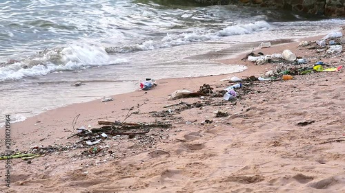 sunset on sea with foam and waste are left on the beach and the waves blew them into the sea1 photo