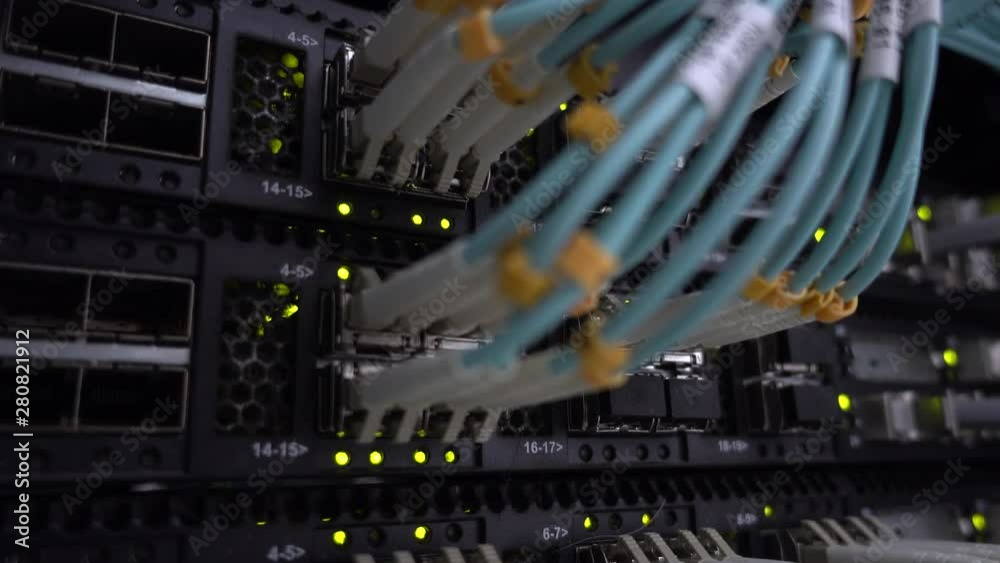 Close-up view of modern internet network switch with plugged ethernet cables