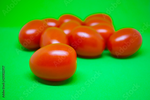 Red tomatoes on green background. Vegetables  still life