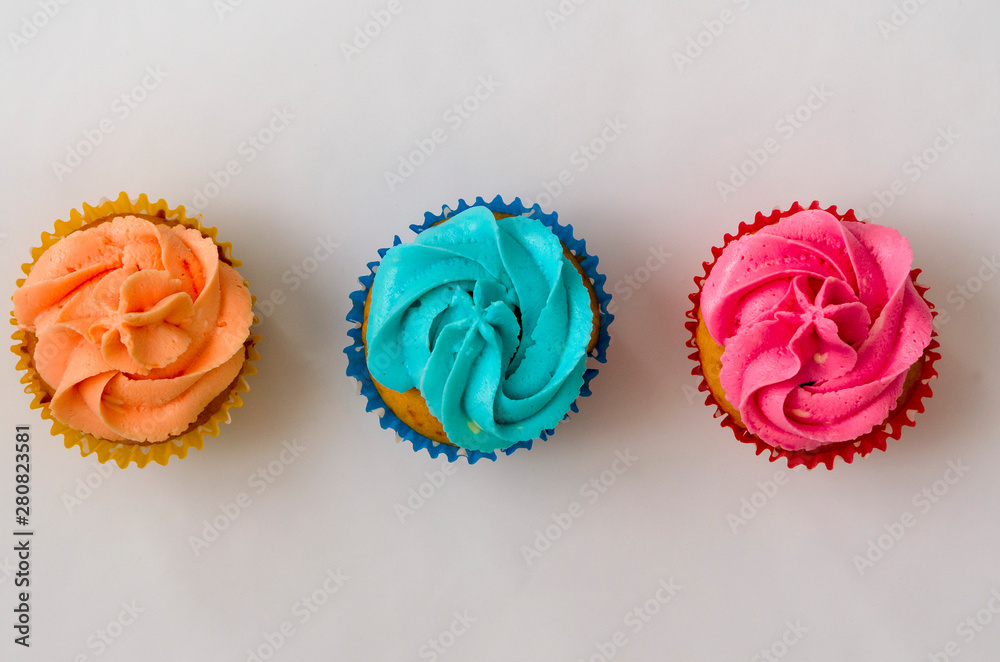 the Colorful homemade cupcakes on a white background the Colorful homemade cupcakes on a white background
