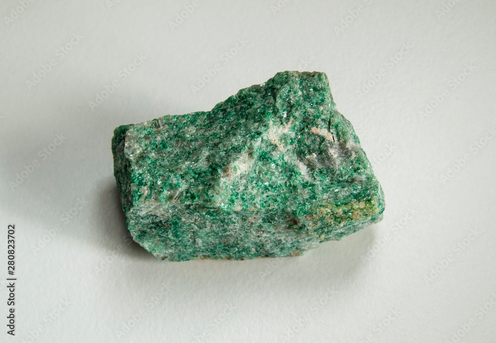 Macro shooting of natural mineral rock specimen - raw listvenite (Listwanite) stone. Origin: Russian Federation, Ural. On a white background. Macro shooting of natural mineral rock specimen - raw listvenite (Listwanite) stone. Origin: Russian Federation, Ural. On a white background.