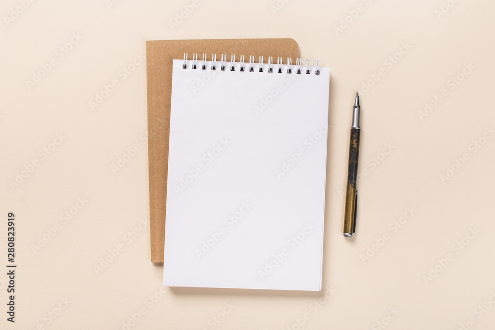 school notepad and pen on the beige desk. spiral notepad on a table. flatlay school notepad and pen on the beige desk. spiral notepad on a table. flatlay