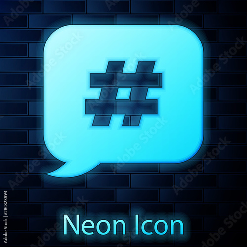 Glowing neon Hashtag speech bubble icon isolated on brick wall background. Concept of number sign, social media marketing, micro blogging. Vector Illustration