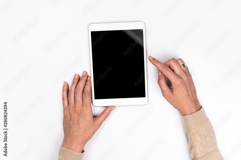 Closeup shot of Woman's hands with perfect manicure holding tablet, Empty display device. with clipping path. Closeup shot of Woman's hands with perfect manicure holding tablet, Empty display device. with clipping path.