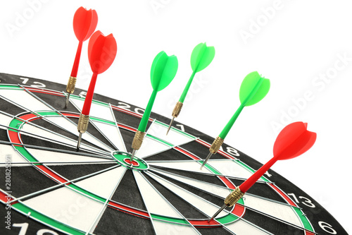 Dart board with color arrows hitting target, closeup