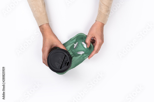 Female hand with paper cup isolated on white