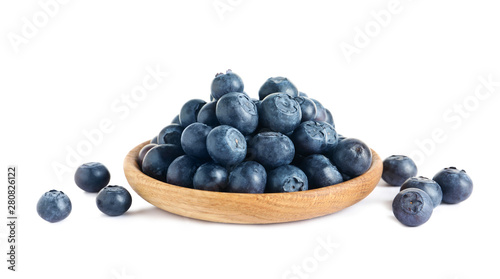 Plate of fresh raw blueberries isolated on white