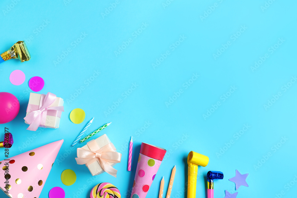 Flat lay composition with different birthday party items on light blue background, space for text Flat lay composition with different birthday party items on light blue background, space for text