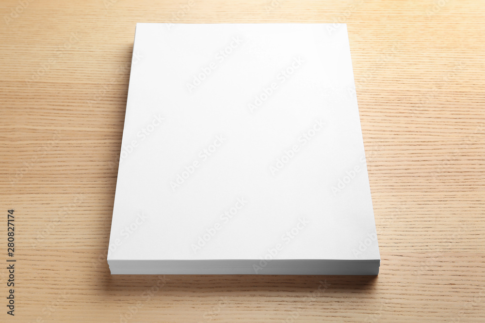 Stack of blank paper sheets for brochure on wooden background. Mock up Stack of blank paper sheets for brochure on wooden background. Mock up