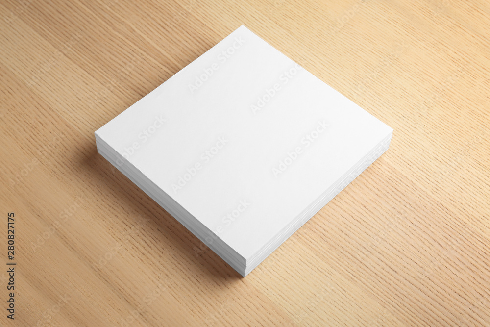 Stack of blank paper sheets for brochure on wooden background. Mock up Stack of blank paper sheets for brochure on wooden background. Mock up
