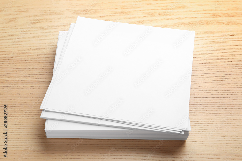 Stack of blank paper sheets for brochure on wooden background. Mock up Stack of blank paper sheets for brochure on wooden background. Mock up