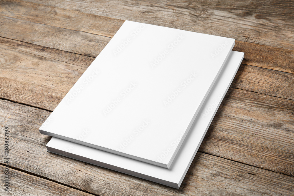 Stack of blank paper sheets for brochure on wooden background. Mock up Stack of blank paper sheets for brochure on wooden background. Mock up