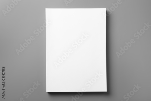 Stack of blank paper sheets for brochure on grey background, top view. Mock up © New Africa