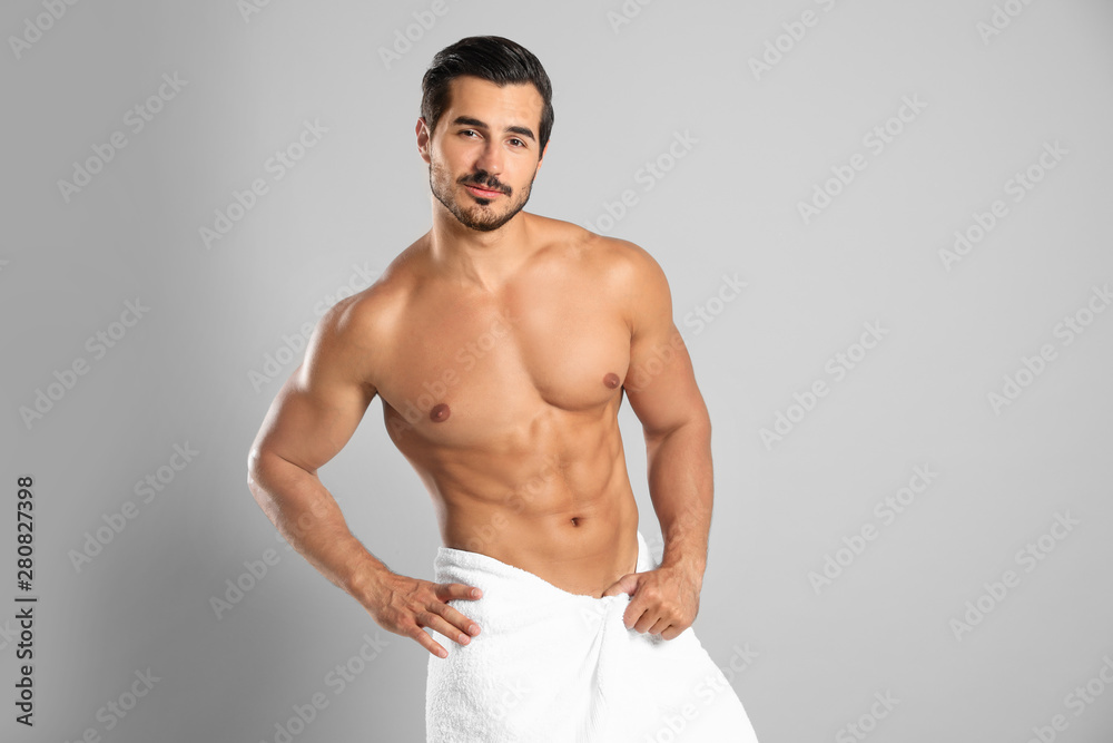 Young man with slim body on grey background Young man with slim body on grey background