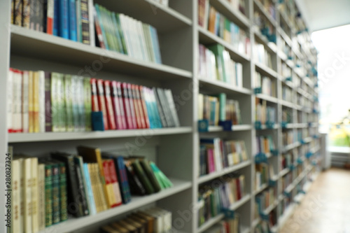 Blurred view of shelves with books in library