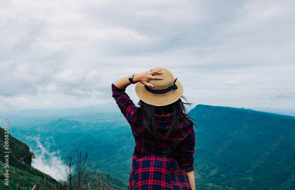 Woman travel rainy season mountain view relax in the holiday
