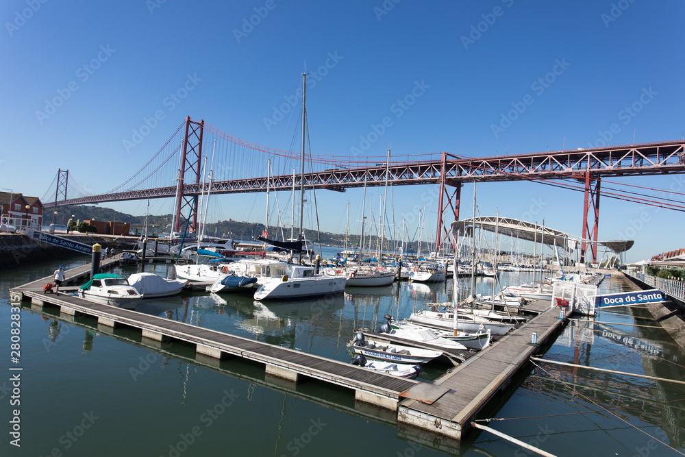 Lisbon, Portugal, Europe - View of Lisbon cityscape with typical tram, flag and Tejo River