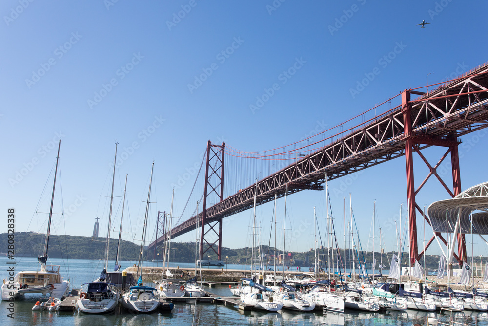 Lisbon, Portugal, Europe - View of Lisbon cityscape with typical tram, flag and Tejo River