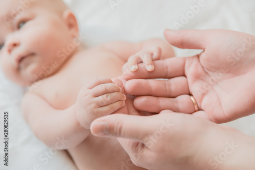 little baby mom gently holds on a white background