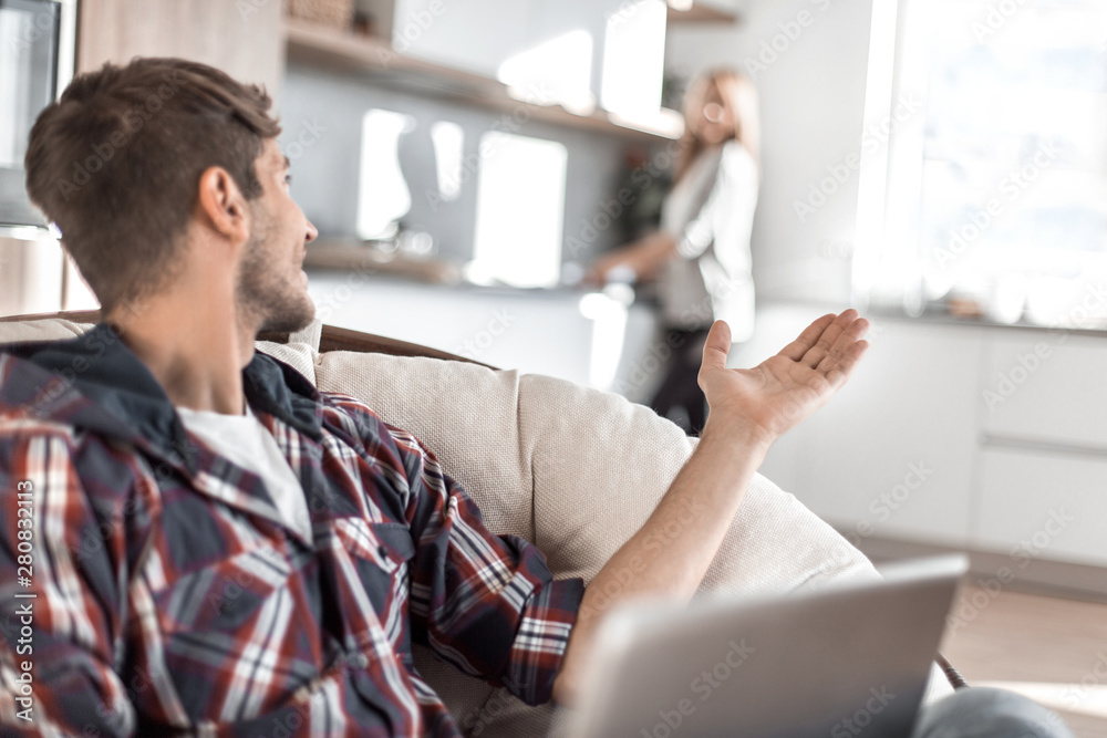 close up. handsome guy with a laptop in the home interior close up. handsome guy with a laptop in the home interior