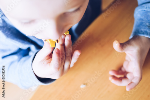 Little boy is eating donut