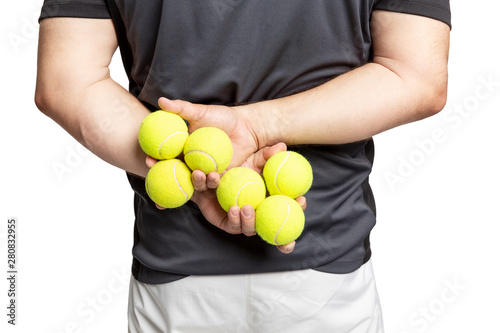 A man holds tennis balls in his hands. Back view. Close-up. Isolated on a white background.