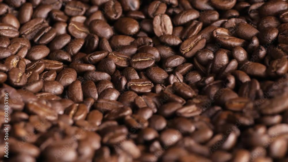 Roasted coffee bean. Fragrant coffee beans scrolls slowly around the camera. Slow Motion Close Up of Whole Roasted Coffee Beans. Roasted coffee bean. Fragrant coffee beans scrolls slowly around the camera. Slow Motion Close Up of Whole Roasted Coffee Beans.