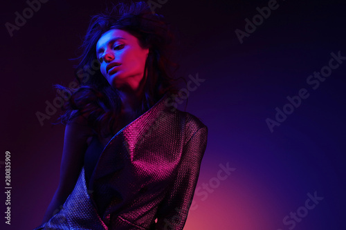 High fashion girl model in stylish clothing in color neon light