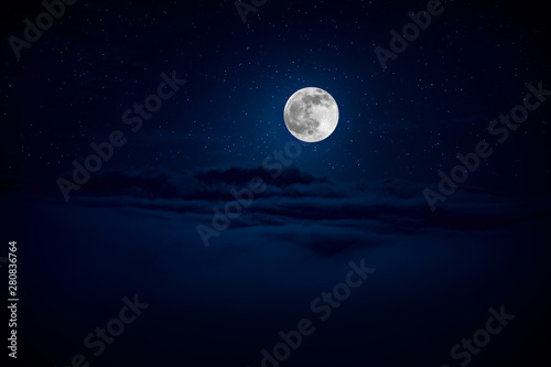 backgrounds night sky with stars and moon and clouds. Beautiful full moon over clouds © zef art