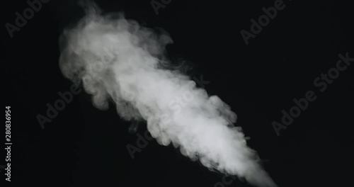 Slow motion of water vapor stream comes from below over black background