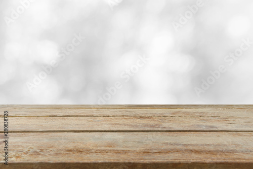 Empty wooden table top with blurred whitebackground. Can be used for display or montage your products.